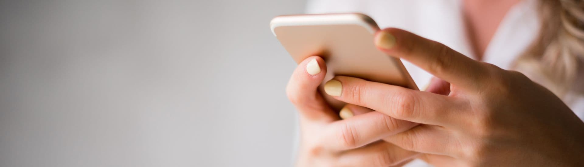 A person holds a smartphone in their hands.