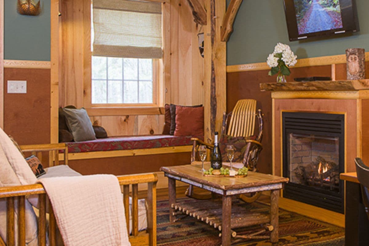 Cozy living room with wooden accents, a fireplace, and comfortable seating.